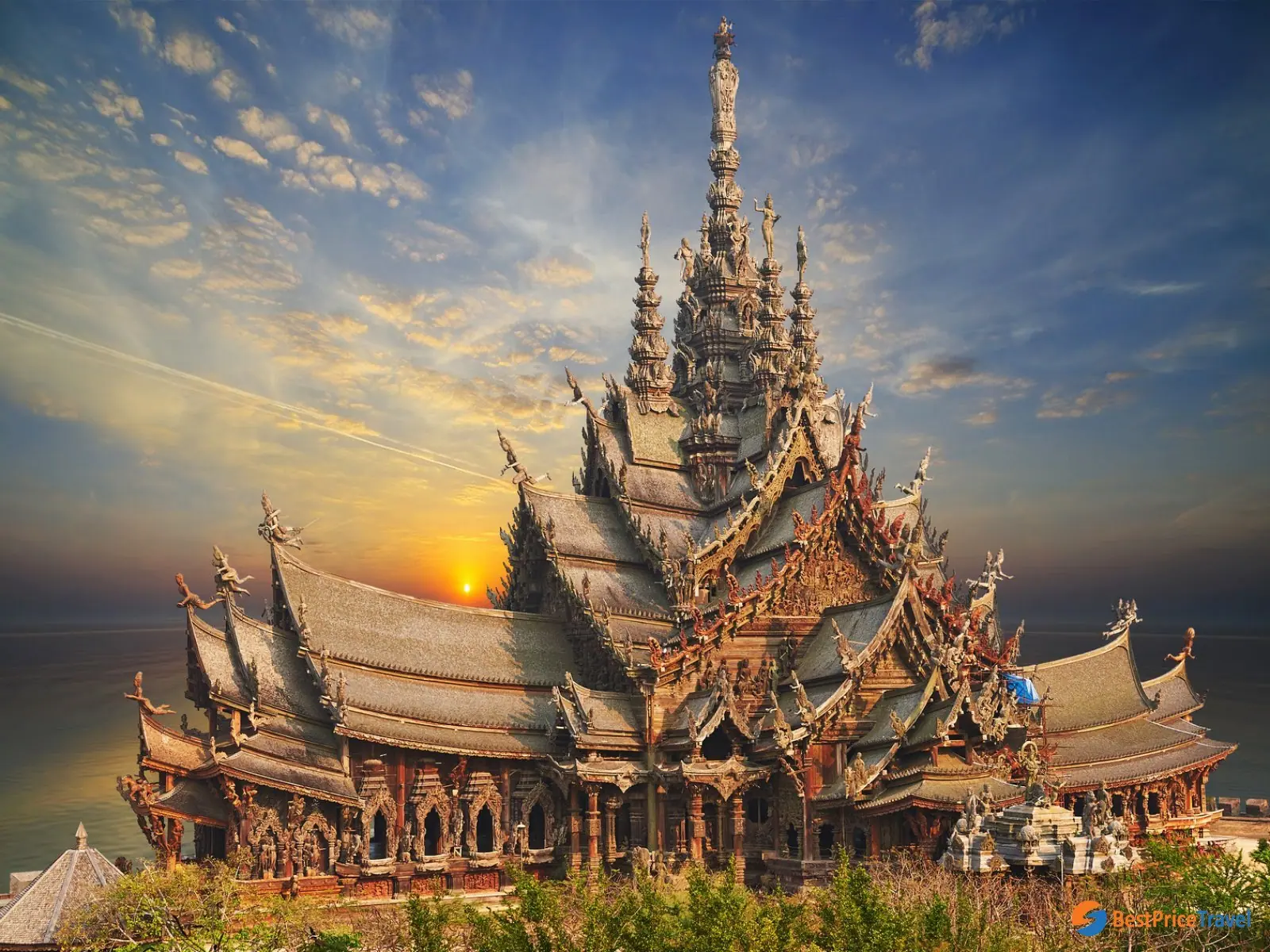 The carved all-timber Sanctuary of Truth rising against the sky at Pattaya, Thailand